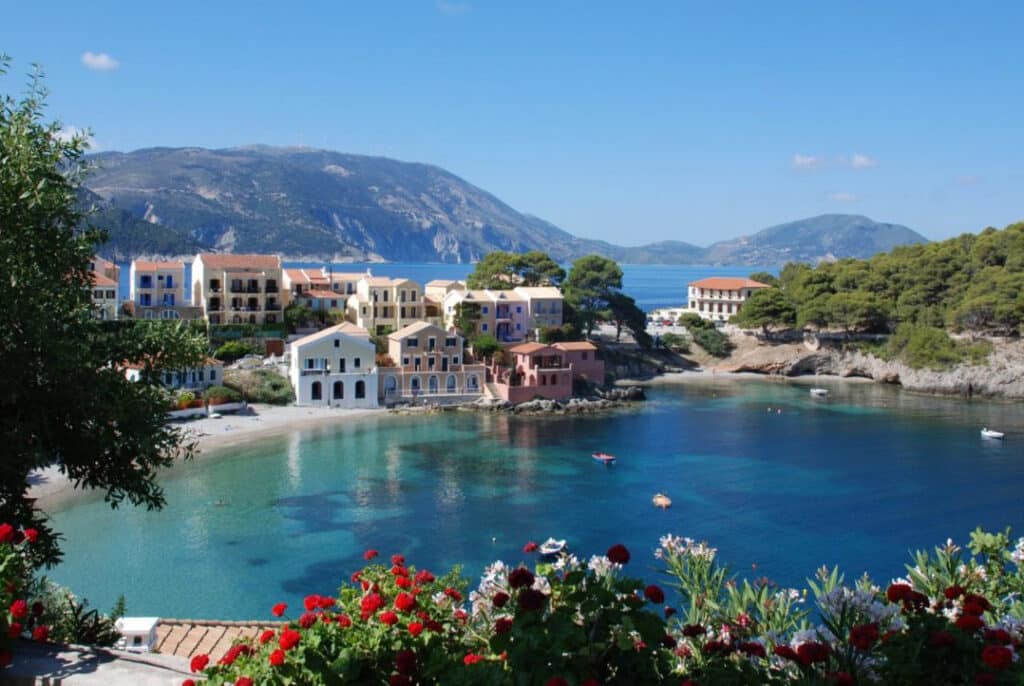 The colourful harbour village of Assos in Kefalonia with traditional houses set around a picture-perfect bay.