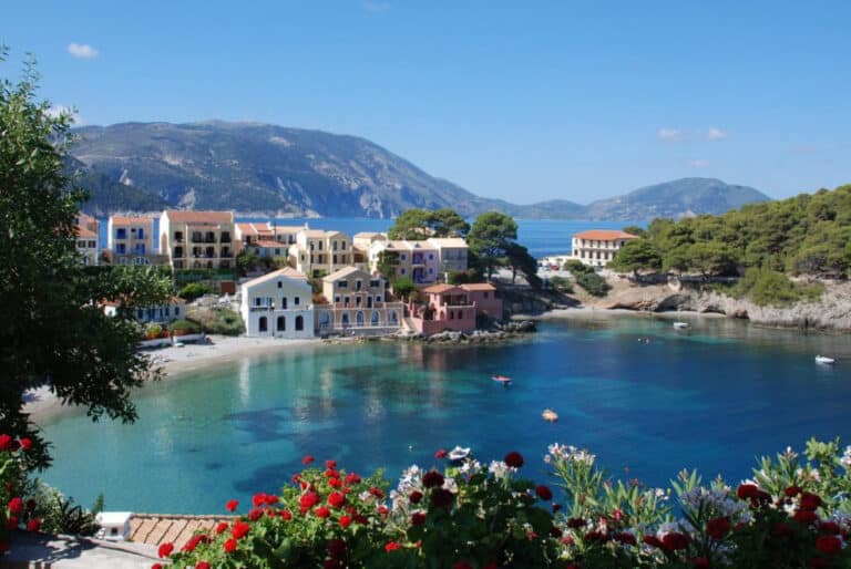 The colourful harbour village of Assos in Kefalonia with traditional houses set around a picture-perfect bay.
