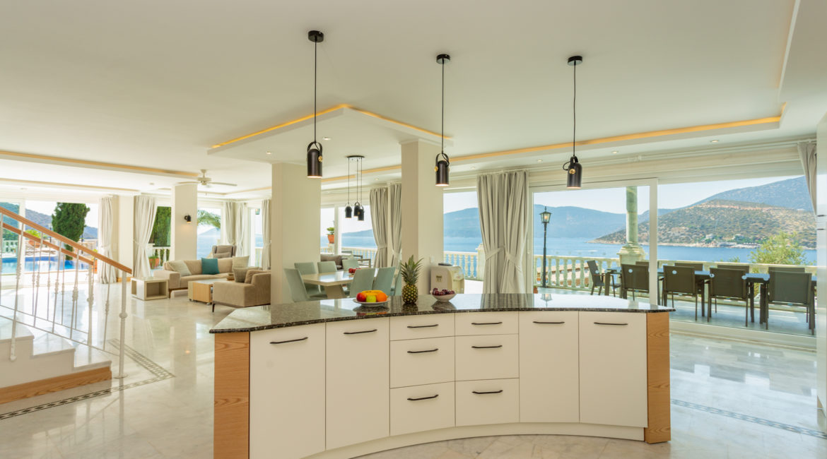 Open plan kitchen, dining and living area of Mavi Koy and views out across the bay