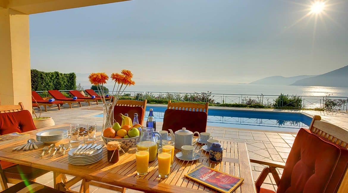 Fiskardo House outside dining with pool and sea views