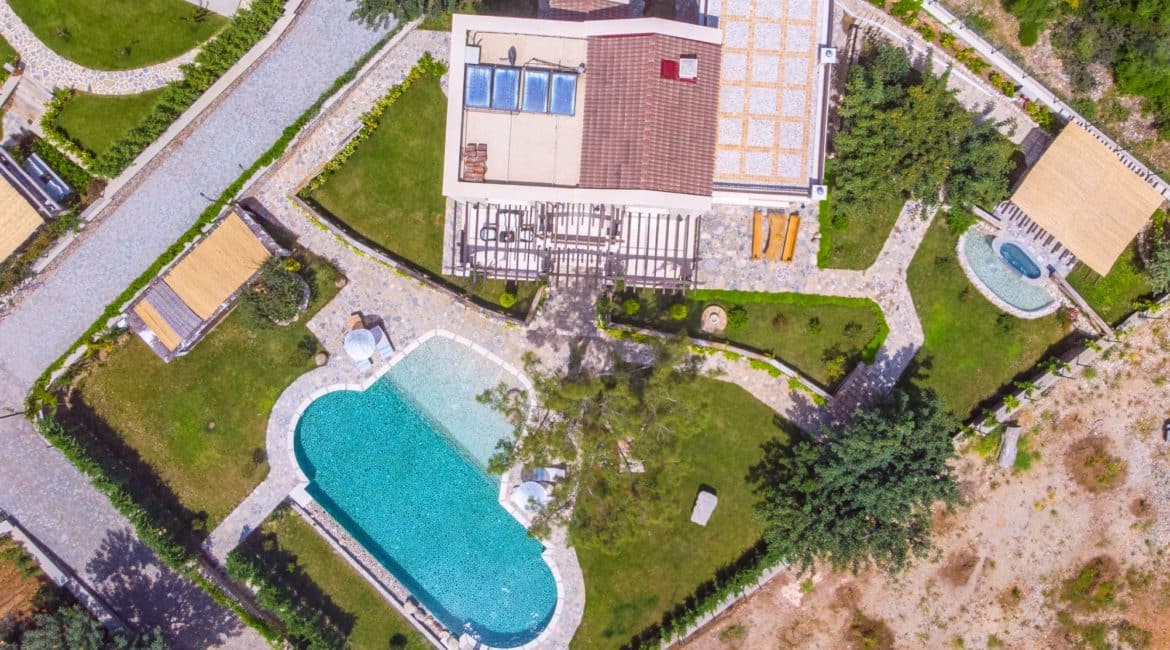 Gemile aerial footage of the large grounds, pool and house