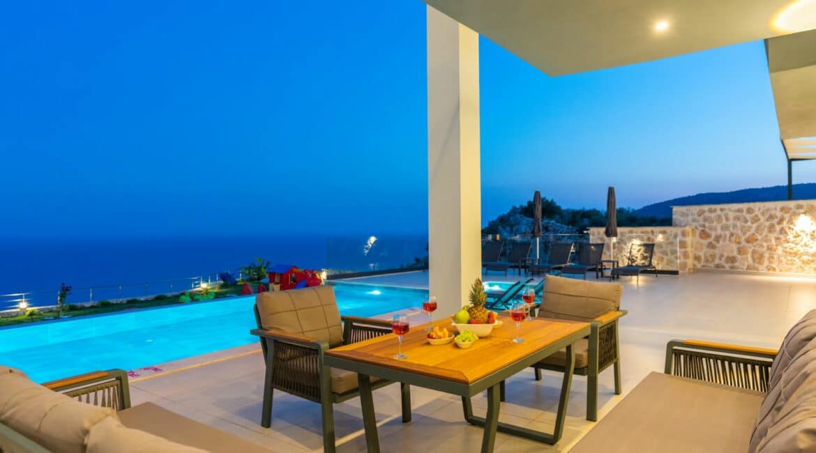 Villa Skyline alfresco seating area by night and pool views