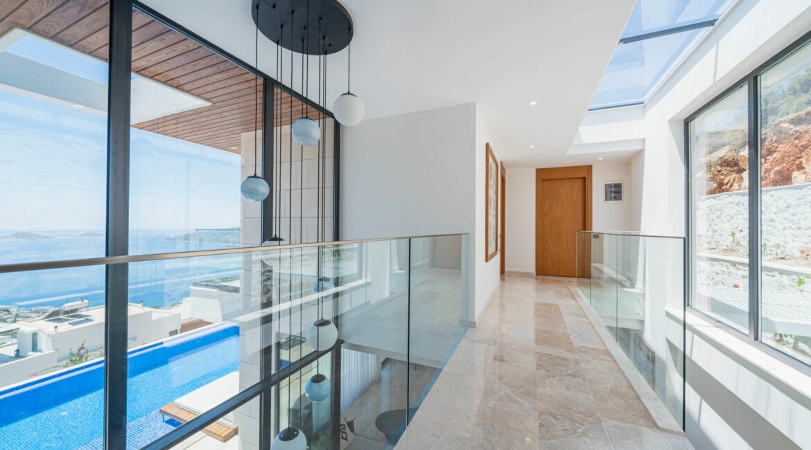 Villa Anatolia hallway and floor to glass ceiling windows imbibing the surrounds
