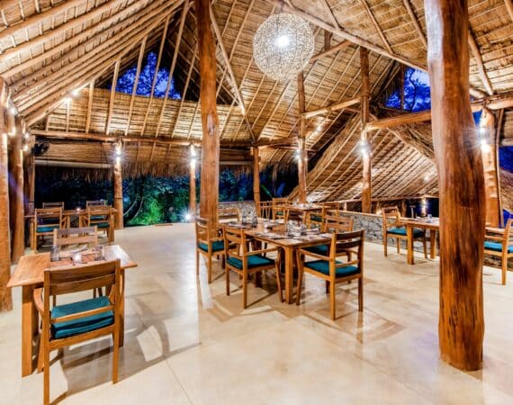 Gal Oya Lodge dining room – Open-sided indoor-outdoor dining space blending natural materials and jungle views in Gal Oya National Park, Sri Lanka.