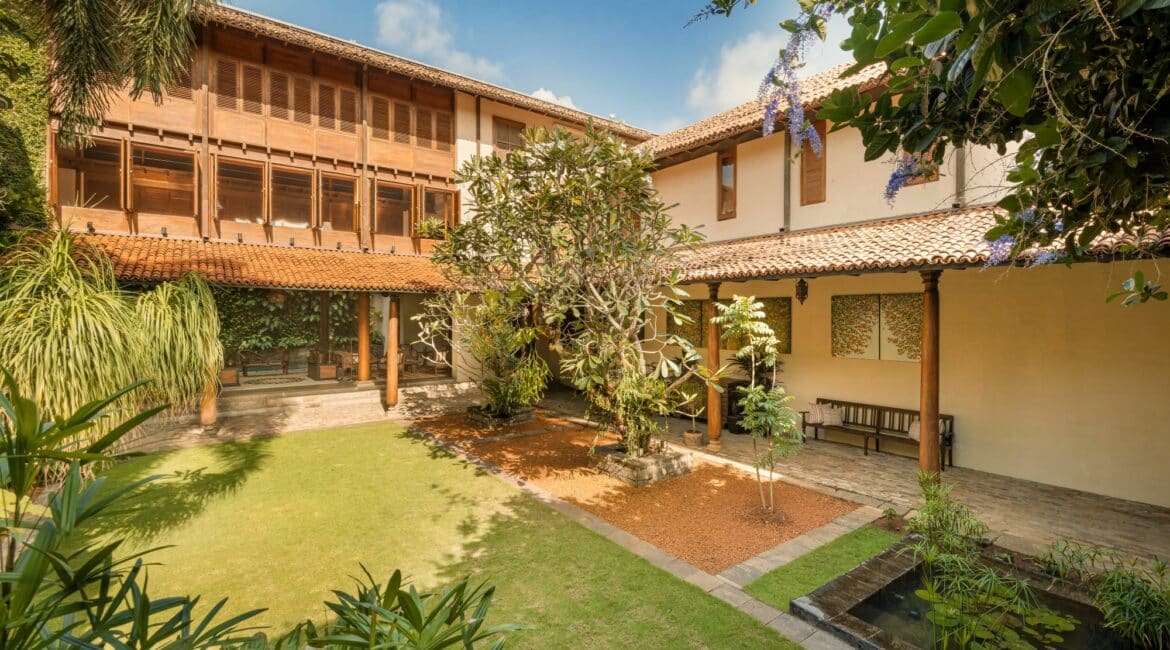Manicured green lawns and lush tropical planting in the courtyard at ISHQ Colombo – a serene garden sanctuary in the heart of Sri Lanka’s capital.