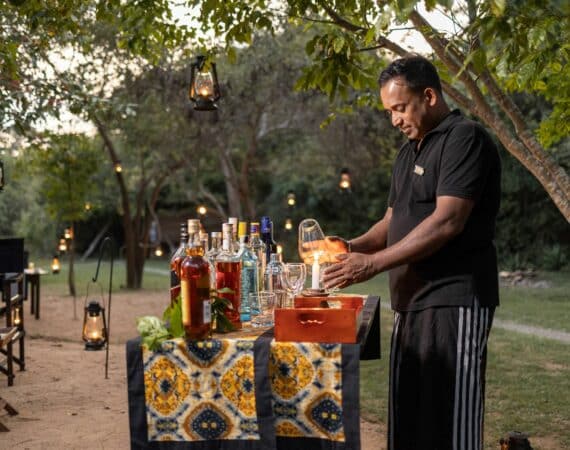 Leopard Trails Wilpattu Camp Bar – Sundowners being expertly poured by the team, capturing the relaxed, elegant atmosphere of safari evenings in Sri Lanka.