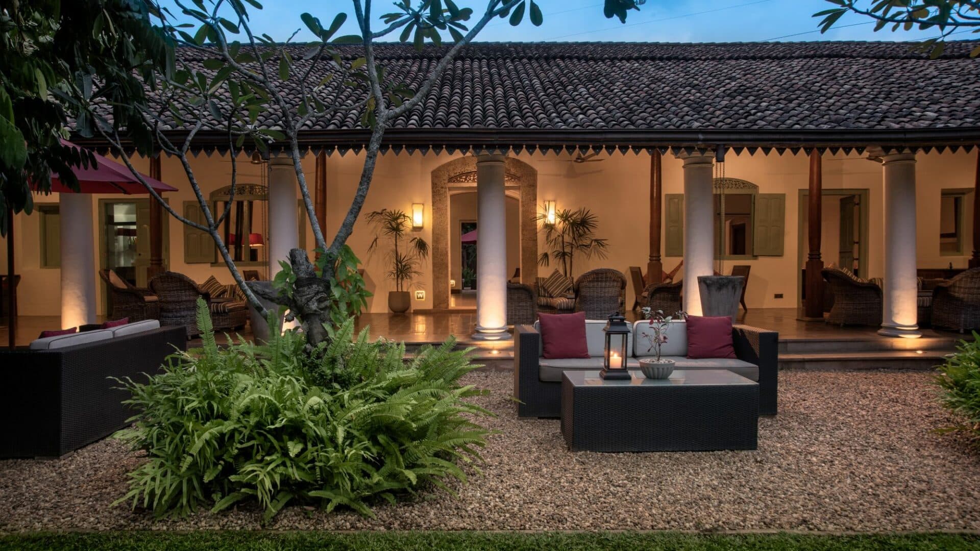 Colonial-style verandas at The Wallawwa near Colombo, Sri Lanka, softly lit at dusk – a serene setting for relaxation before or after your island journey.
