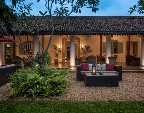 Colonial-style verandas at The Wallawwa near Colombo, Sri Lanka, softly lit at dusk – a serene setting for relaxation before or after your island journey.