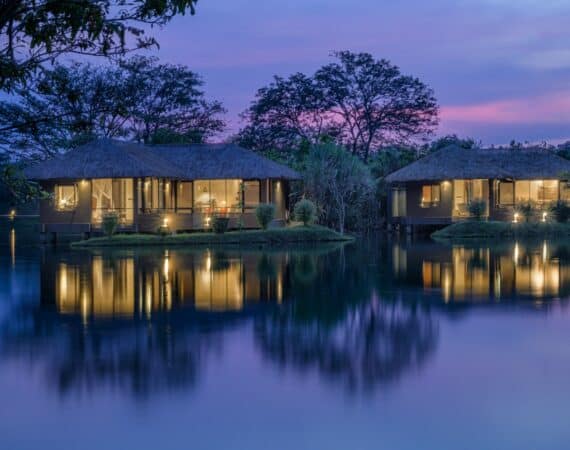 Elegant Water Garden Sigiriya suite at dusk with Sigiriya Rock in view, bathed in a purple twilight hue – luxury boutique hotel in Sri Lanka’s Cultural Triangle