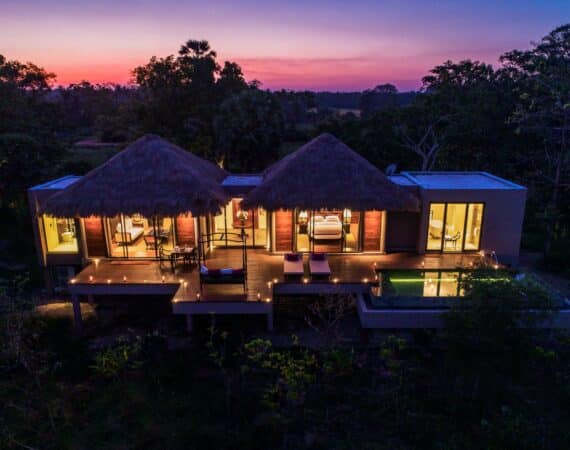 Deluxe Pool Villa at Uga Ulagalla at dusk, softly lit against the evening sky – luxury hideaway in Sri Lanka’s Cultural Triangle.