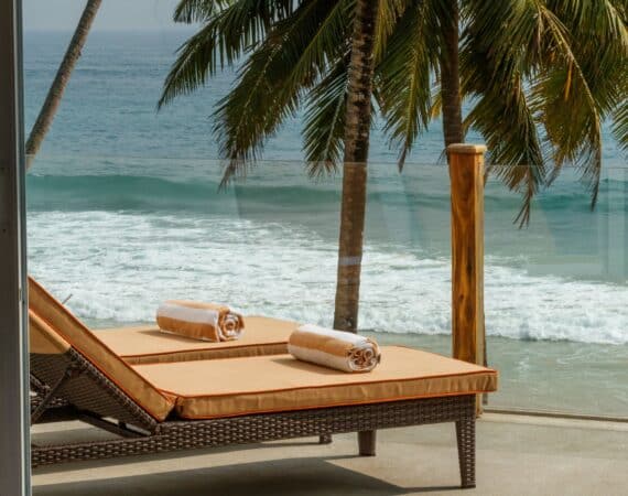 KK Beach Ocean Penthouse Suite – beautifully furnished terrace with daybeds and panoramic sea views.
