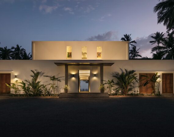 KK Beach Hotel Sri Lanka at dusk – the modern beachfront building softly illuminated against a pink-tinged sky.