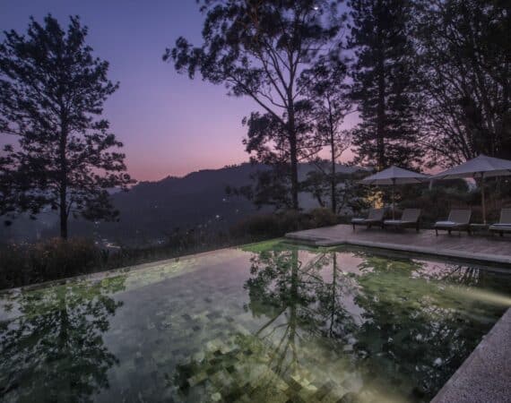 Hill Country landscape seen from poolside at Nine Skies, a tea estate retreat in Sri Lanka