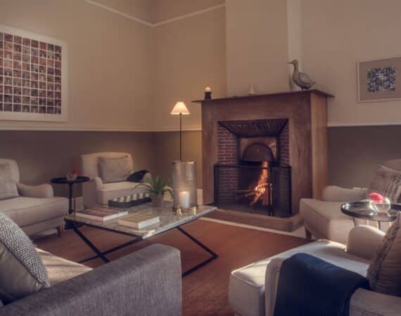 Cosy sitting room with roaring fire at Nine Skies tea bungalow in Sri Lanka’s Hill Country