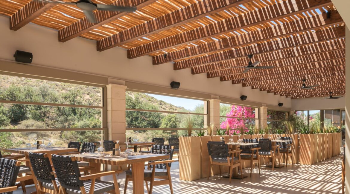 Paralos Irini Mare Agia Galini Crete gorgeous indoor outdoor dining room under the shade of a pergola