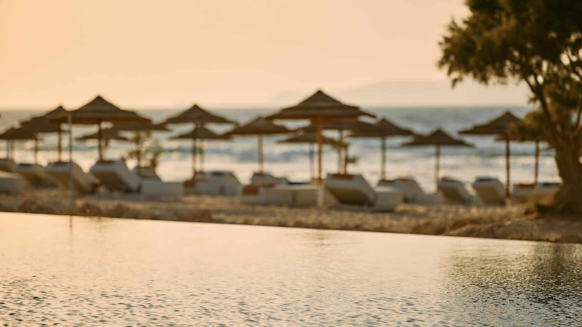 Paralos Kosta Alimia sea facing infinity pool at golden hour