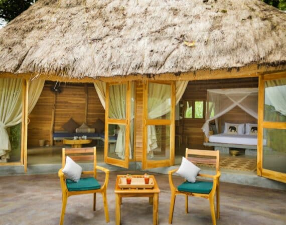 Gal Oya Lodge bungalow suite with alfresco sitting area and stylish indoor lounge, blending natural design with views of Gal Oya National Park, Sri Lanka