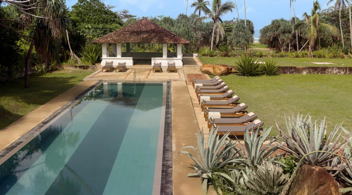 The Villa Bentota with glimpses of the Indian Ocean and a lush garden setting beside the sea.