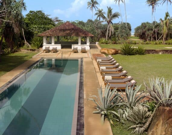 The Villa Bentota with glimpses of the Indian Ocean and a lush garden setting beside the sea.