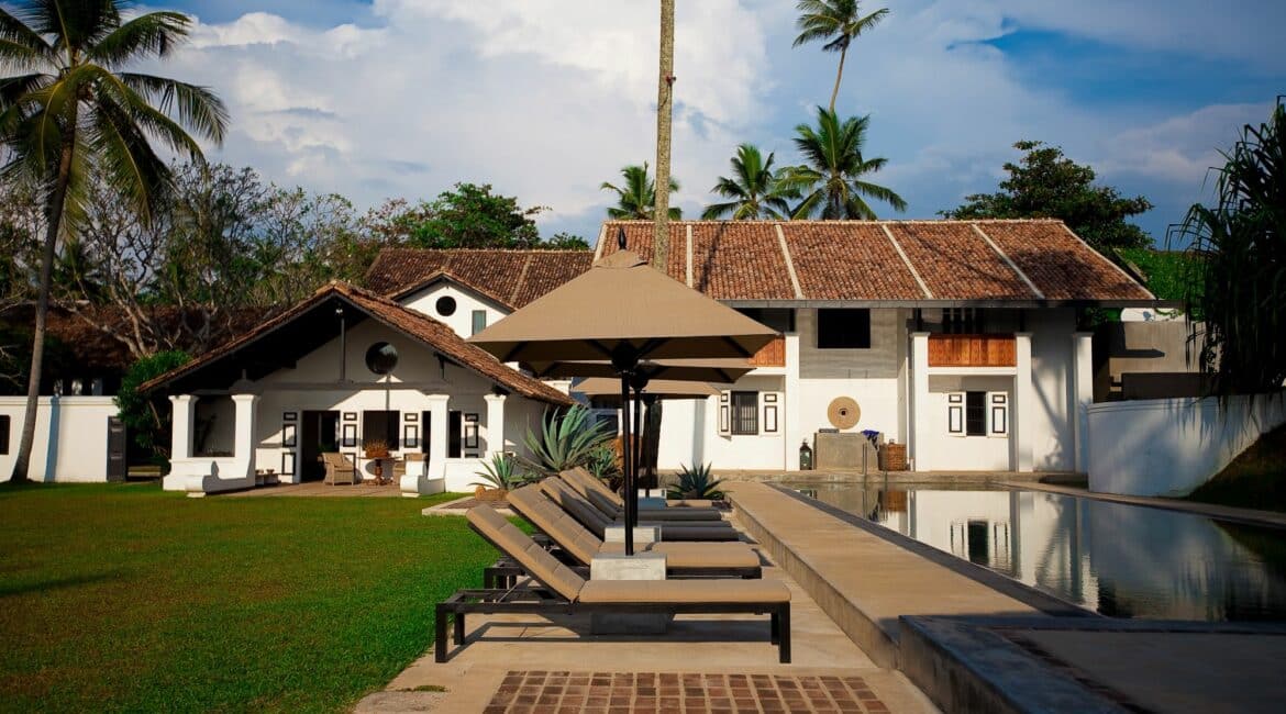 The Villa Bentota stunning exterior swimming pool manicured lawns and blue skies
