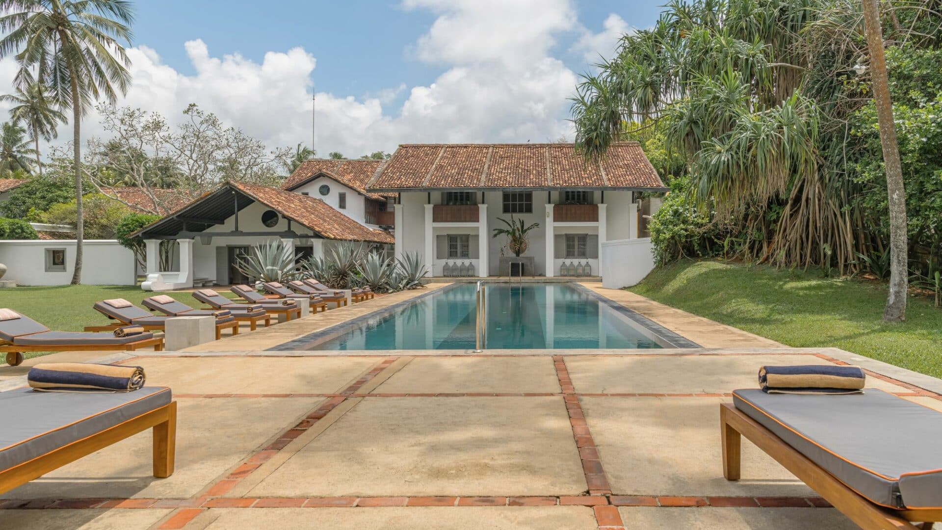 The Villa Bentota swimming pool against the hotel backdrop by day