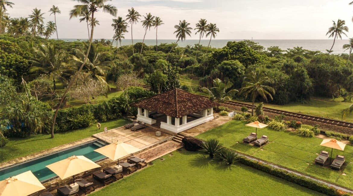 The Villa Bentota swimming pool and gardens by the sea and the railway line