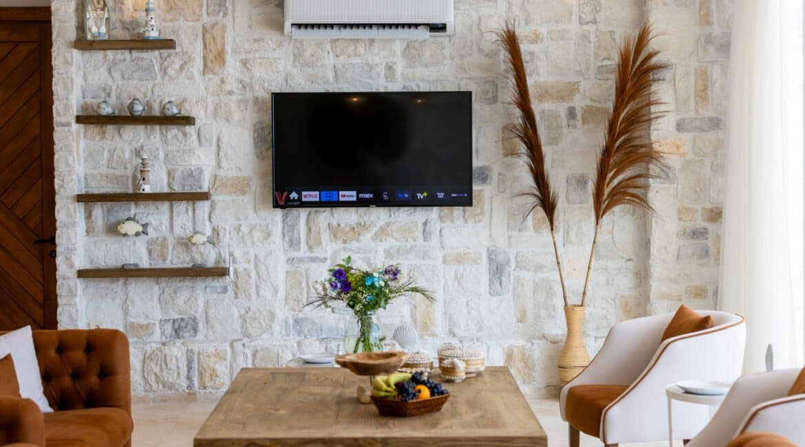 Villa Oasis Kalkan sitting room with television and comfy chairs