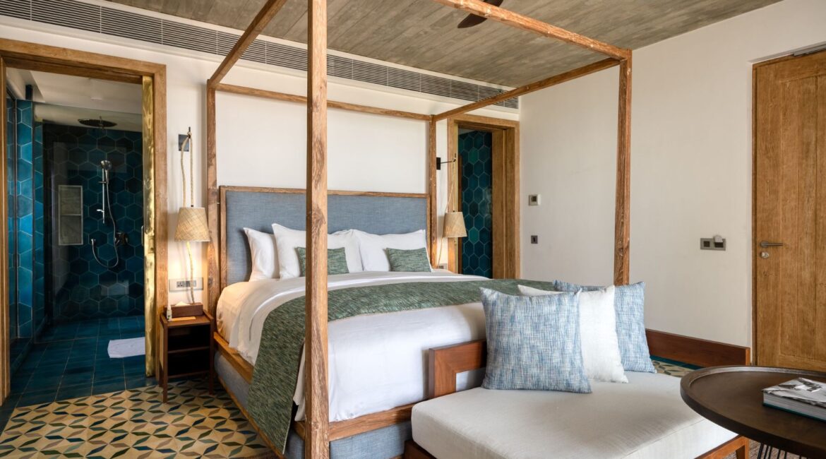 Bay View Suite at Ahu Bay Sri Lanka with a gorgeous four-poster bed, neutral-toned décor, and views towards the tropical garden.