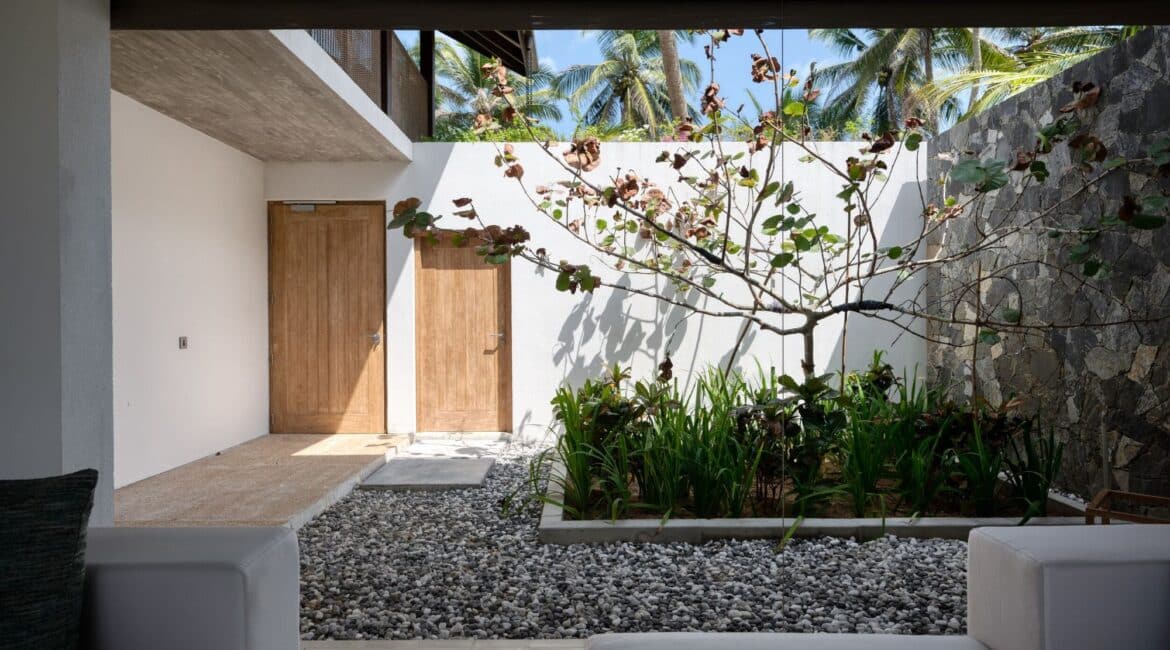 Bay View Suite at Ahu Bay Sri Lanka featuring an open-top roof entrance, blending indoor and outdoor spaces with a light-filled courtyard and garden views.
