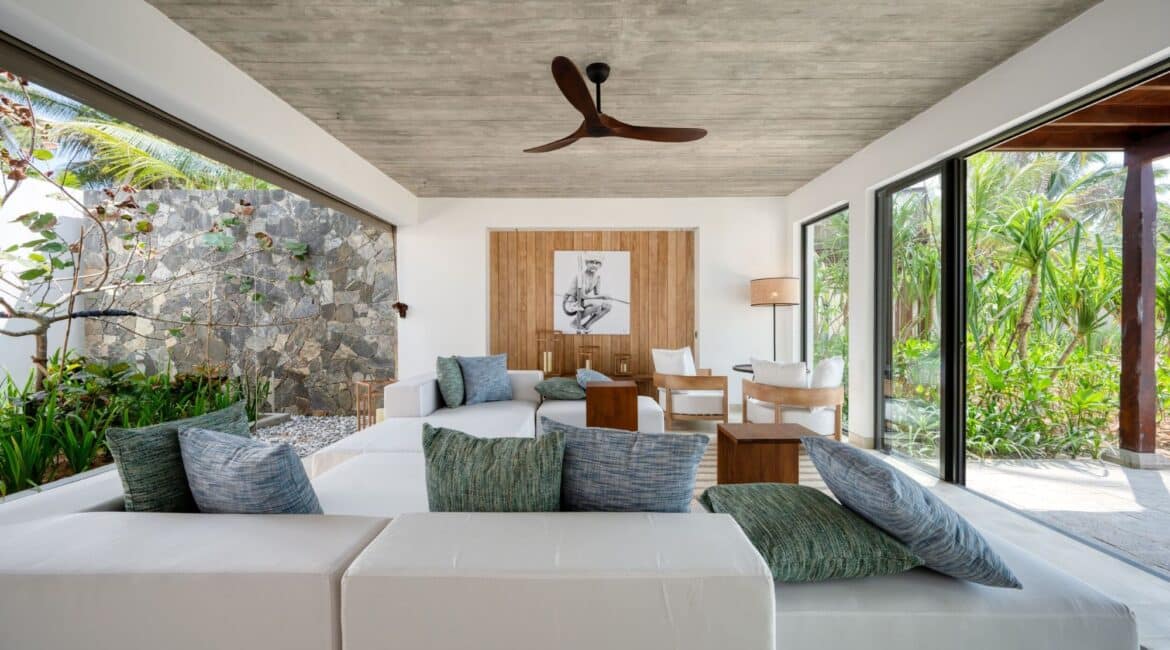 Bay View Suite at Ahu Bay Sri Lanka showcasing stunning indoor-outdoor living with a spacious lounge opening onto a private deck and tropical garden views.