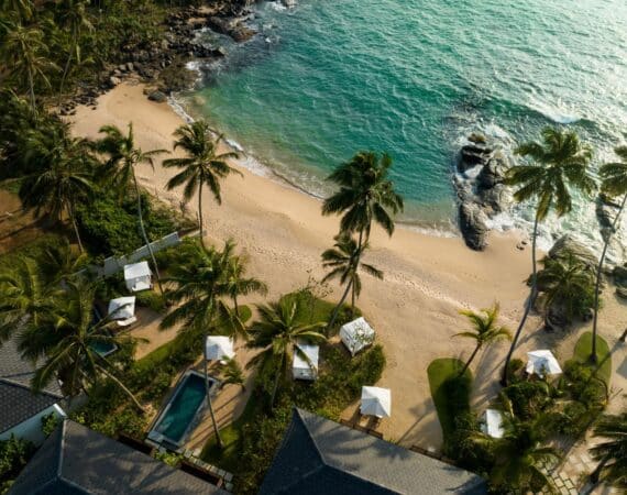 Aerial view of Ahu Bay Sri Lanka featuring the sandy beach, Indian Ocean, and pool rooms with private plunge pools overlooking the water.