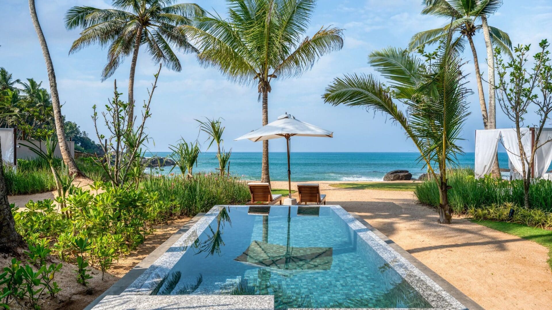 Private plunge pools belonging to the Pool Suites at Ahu Bay Sri Lanka, surrounded by tropical gardens and leading onto the beach