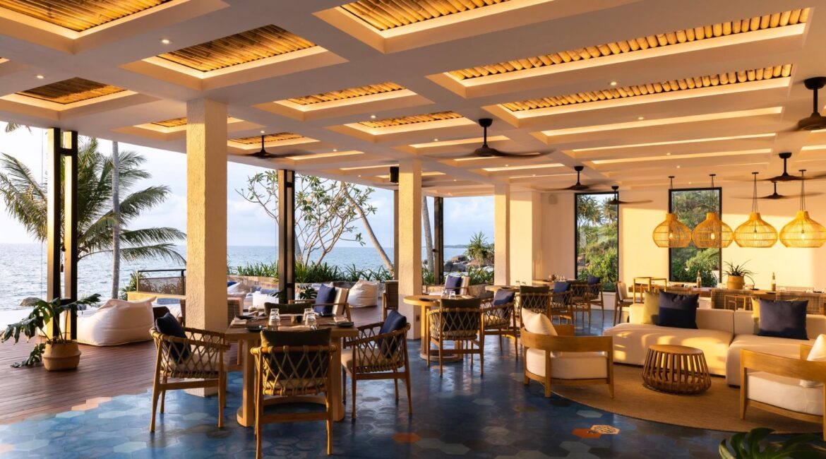 Sitting room at Ahu Bay Sri Lanka opening onto the pool deck with the sea as a spectacular backdrop.