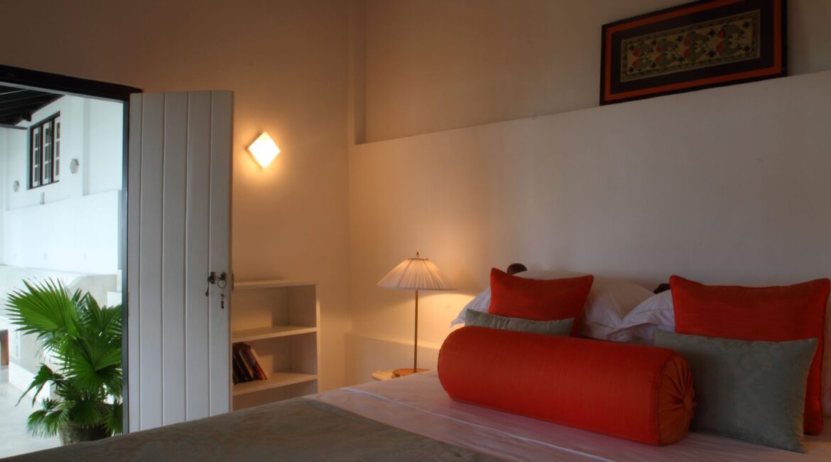 Thambili Bedroom at Coco Tangalla near Tangalle, Sri Lanka – elegant double room with sea and pool views, private balcony, and colonial-style décor