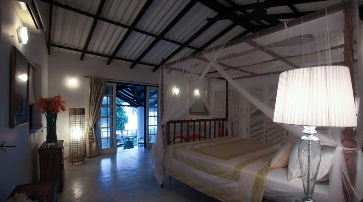 Thambili Room at Coco Tangalla near Tangalle, Sri Lanka at night – garden views and furnished outdoor terrace with seating