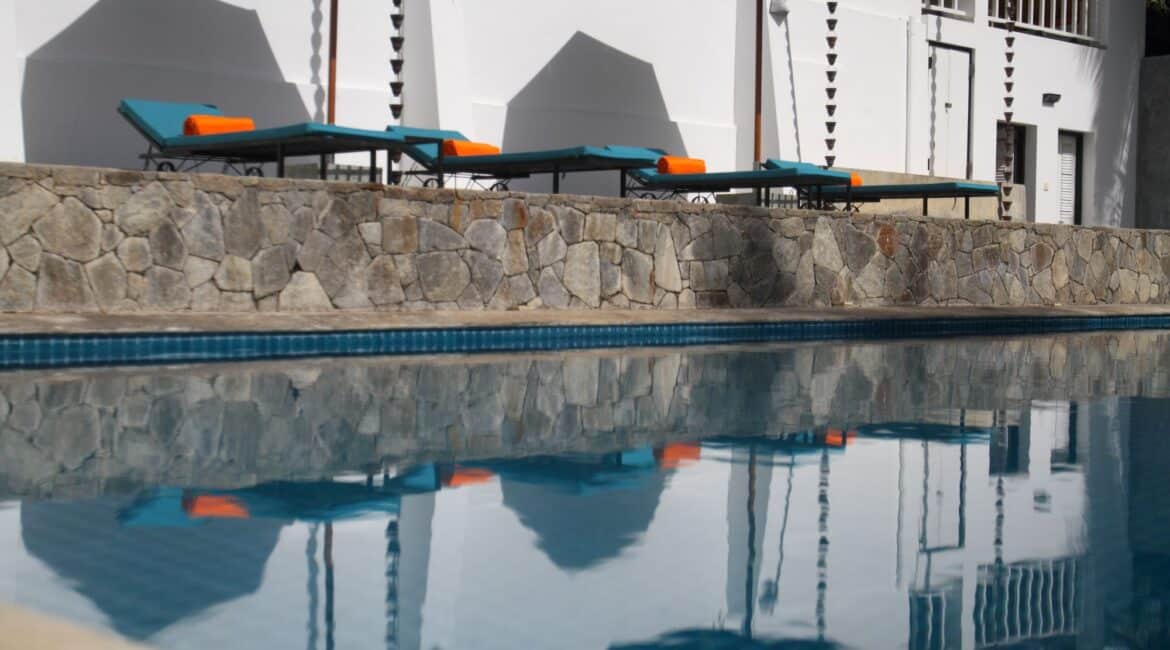 Coco Tangalla Hotel near Tangalle, Sri Lanka – stylish day beds bordering the serene swimming pool, with a backdrop of the villa
