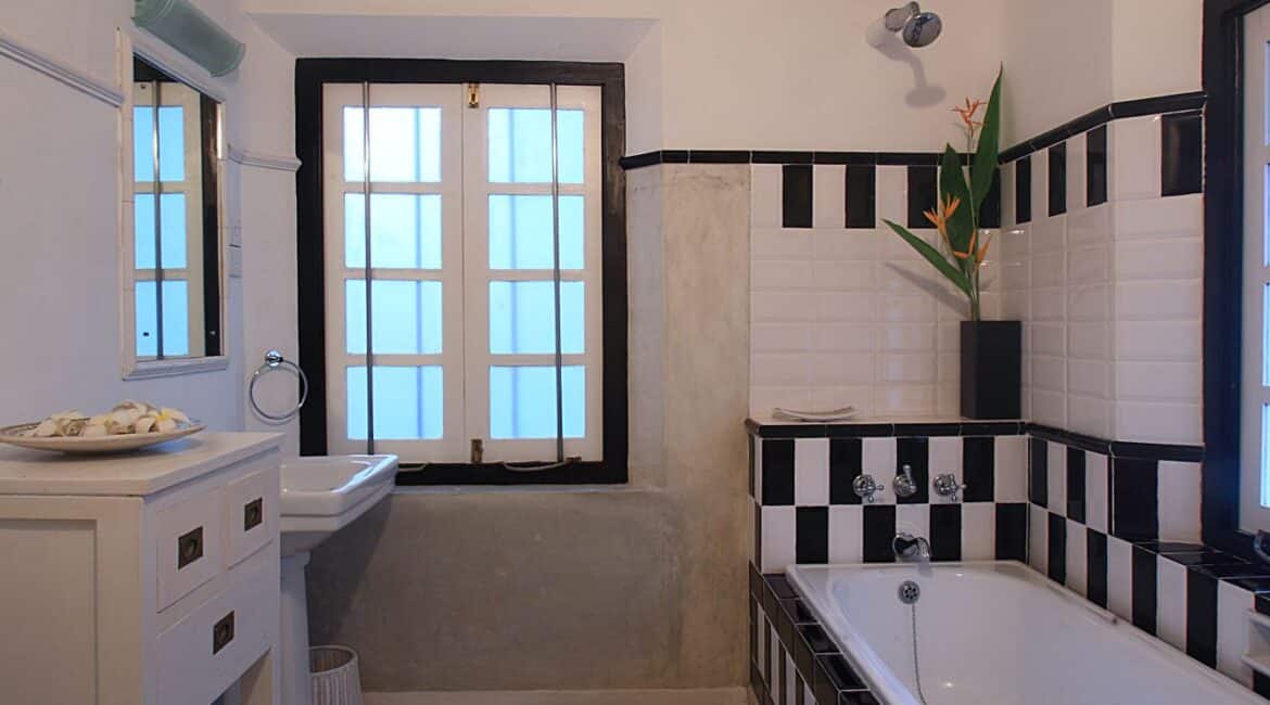 Coco Tangalla Hotel near Tangalle, Sri Lanka – Palmyrah Room’s bathroom featuring a bathtub, walk-in shower, and elegant twin vanities