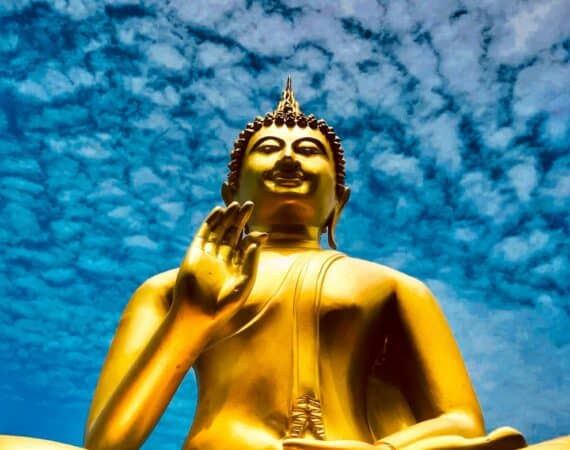 Golden Buddha statue in Colombo, Sri Lanka, beneath blue skies and drifting clouds – a striking symbol of serenity and spiritual heritage on the west coast.