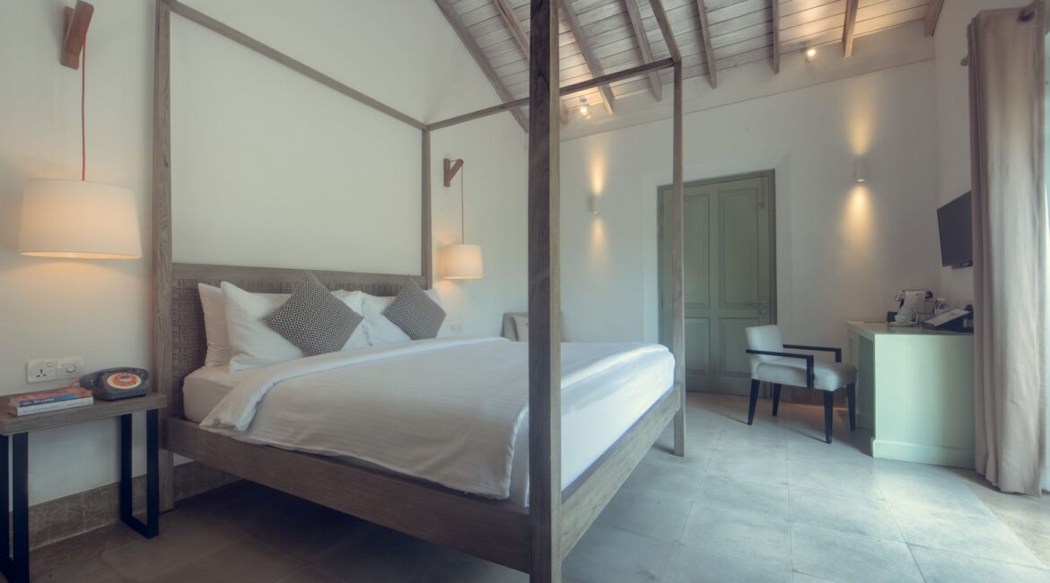 Banyan Bedroom at Fort Bazaar Hotel Sri Lanka with pared-back interiors, neutral tones, a king-size bed, and simple, elegant furnishings.