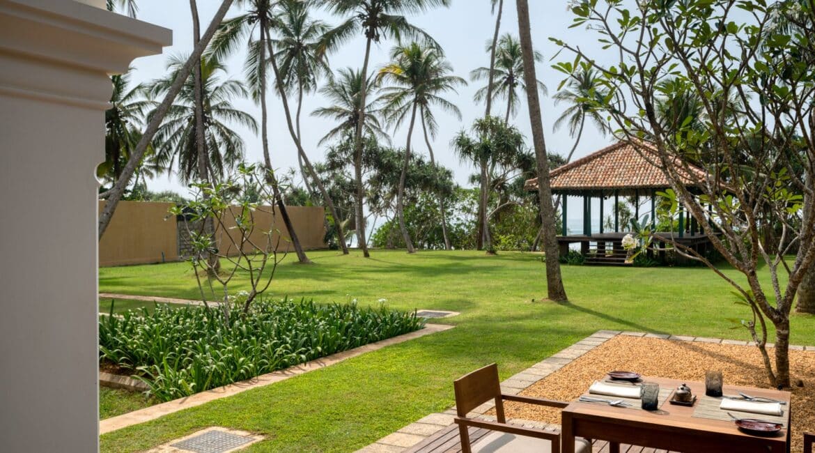 Kayaam House Sri Lanka – elegant breakfast table set on a shaded veranda with sweeping garden views.