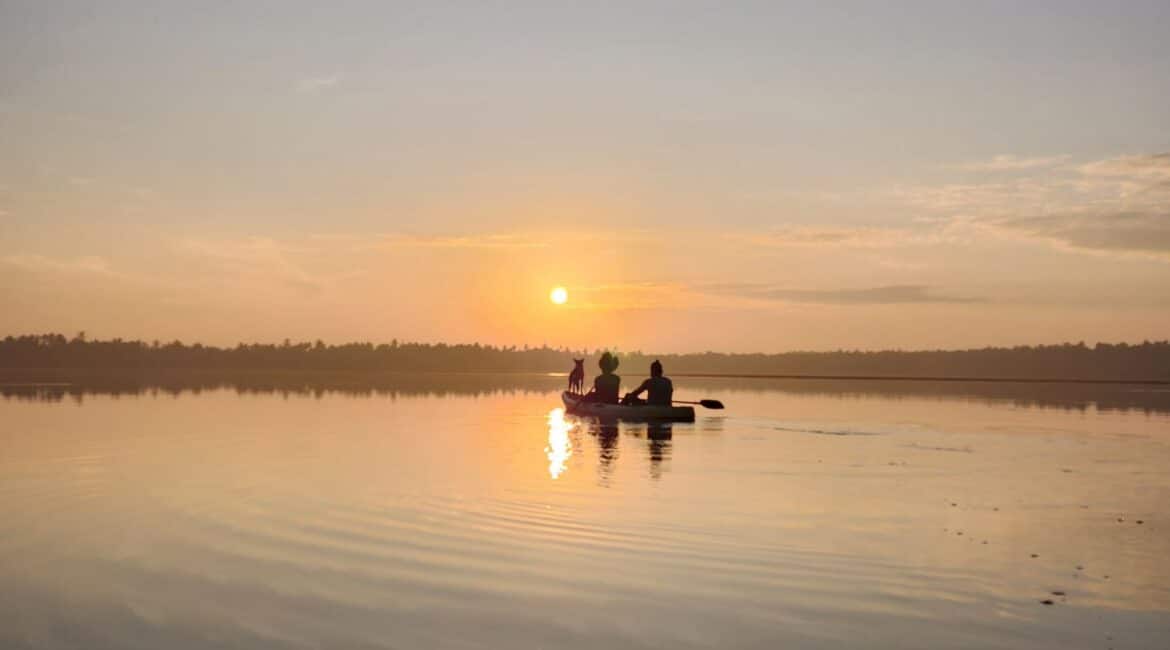Kayaam House Sri Lanka – guest kayaking on the Rekawa Lagoon (tank), surrounded by lush greenery and calm waters.