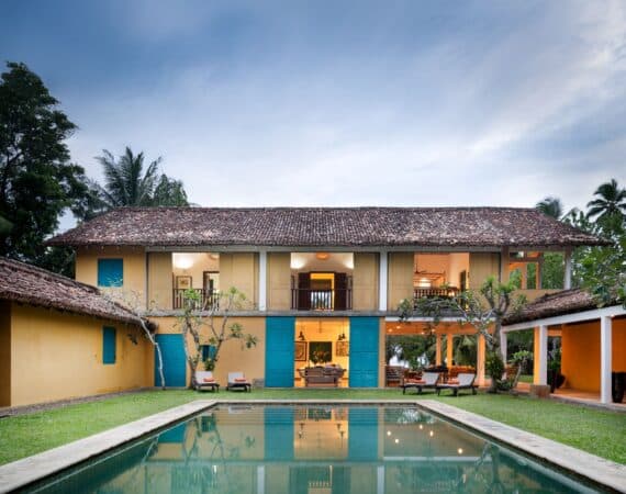 The Last House Tangalle, Sri Lanka – vibrant yellow exterior with colonial charm, set beside a turquoise swimming pool and tropical gardens.