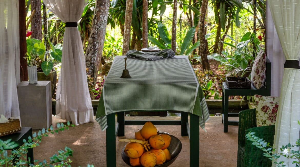 shaded alfresco massage area rrounded by palm trees at Why House Sri Lanka