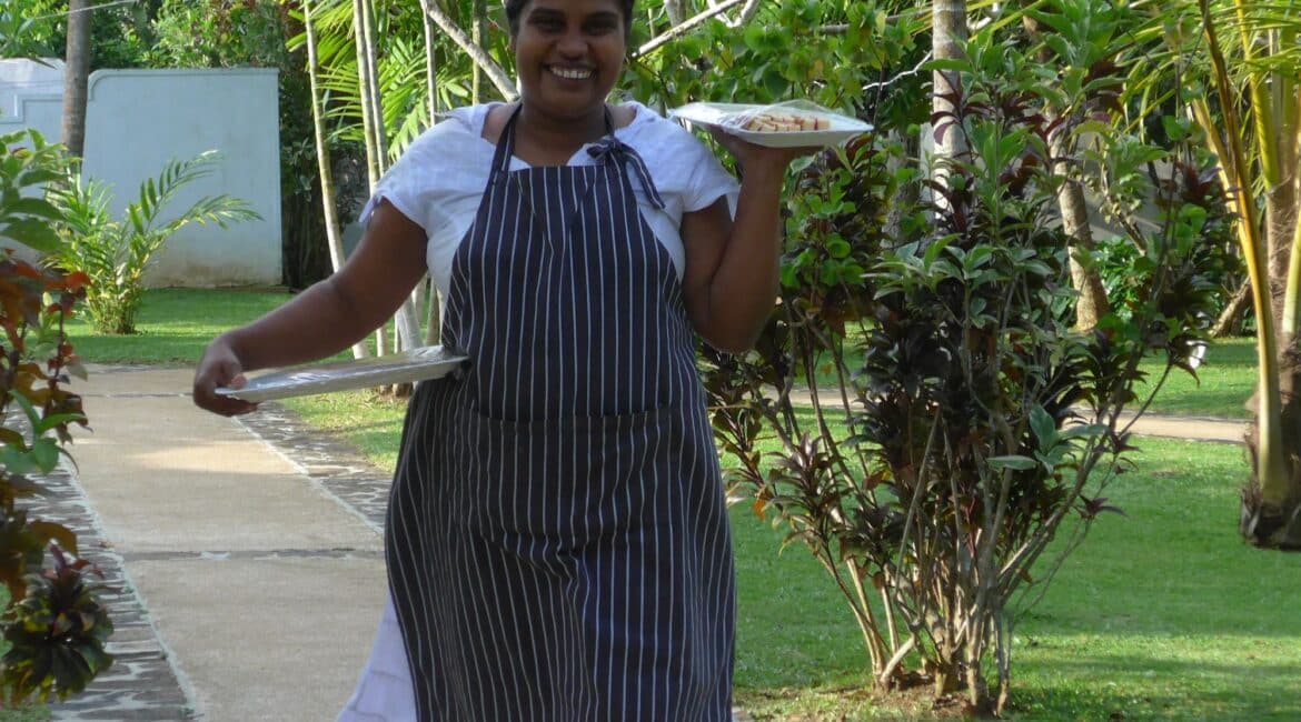 Pastry chef walking through lush gardens at Why House Sri Lanka