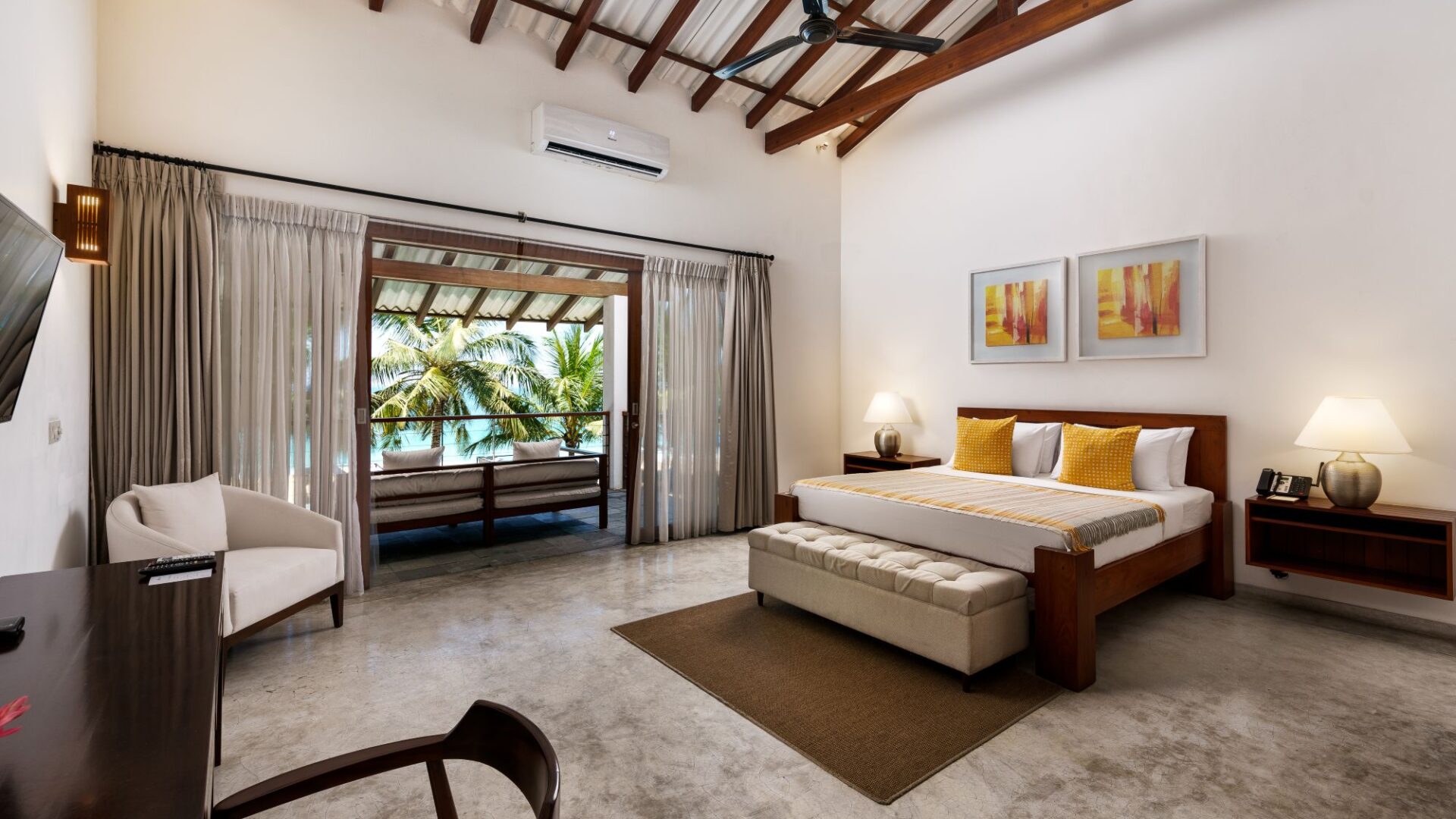 Deluxe Ocean Room at Lantern Boutique Hotel Sri Lanka high-ceilinged interior with elegant neutral design and balcony views of the shimmering Indian Ocean