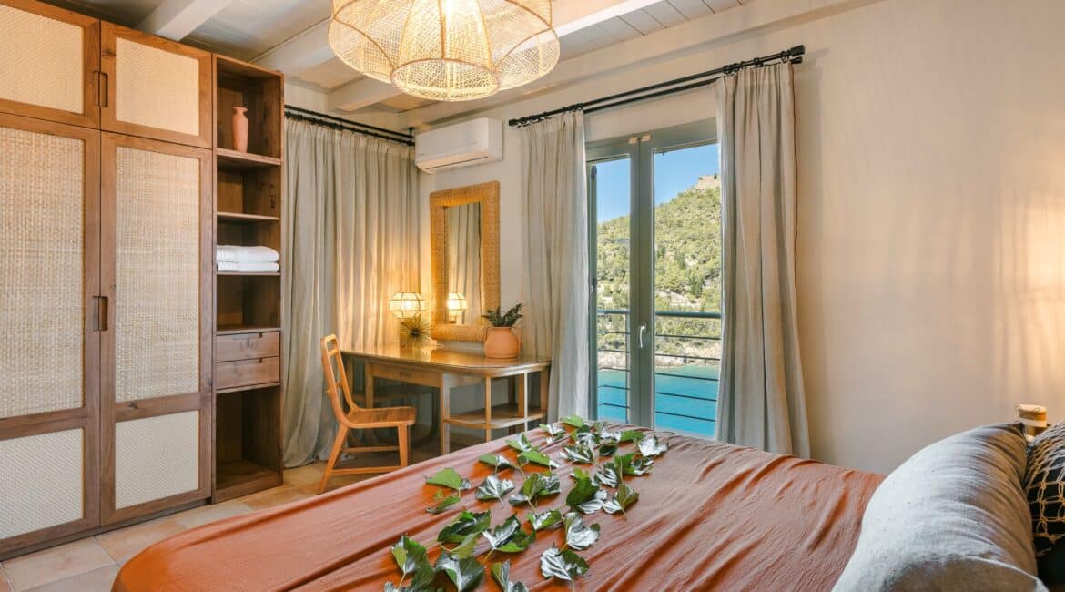Spacious double bedroom with soft furnishings and stunning Ionian views at Villa Nikolis, Braunis Horio, Assos, Kefalonia.