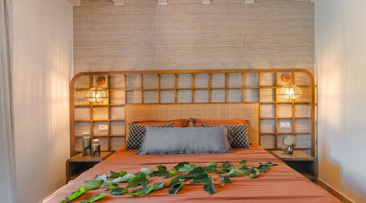 Spacious bedroom with soft furnishings and stunning Ionian views at Villa Nikolis, Braunis Horio, Assos, Kefalonia.