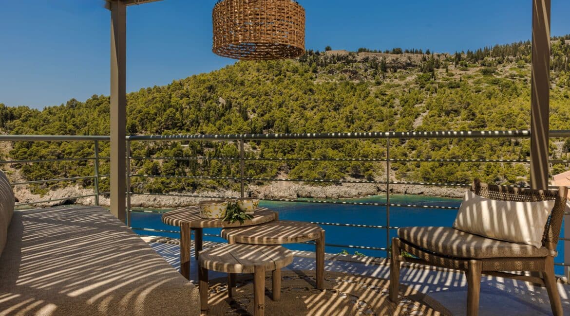 Alfresco seating area under the shade of a pergola and glorious views out to sea at Villa Nikolis, Braunis Horio, Assos, Kefalonia.