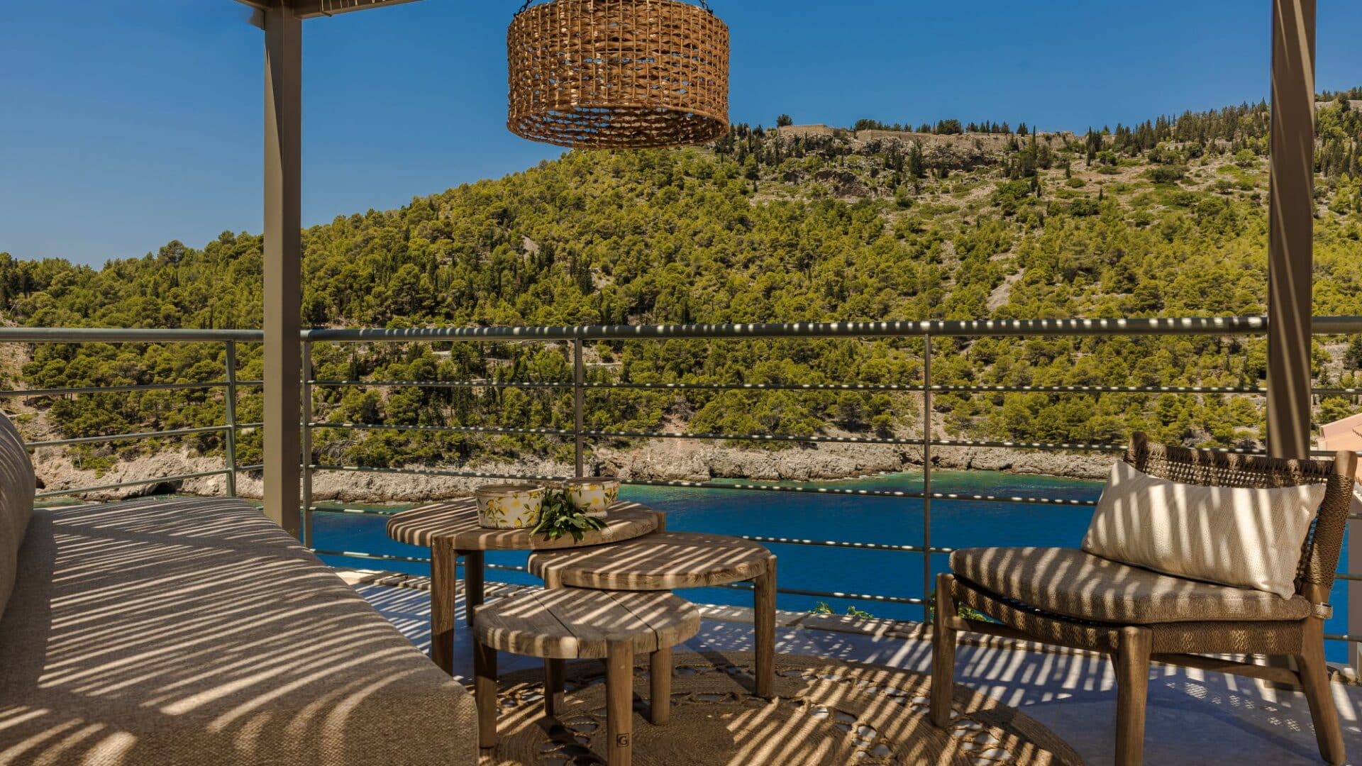 Alfresco seating area under the shade of a pergola and glorious views out to sea at Villa Nikolis, Braunis Horio, Assos, Kefalonia.