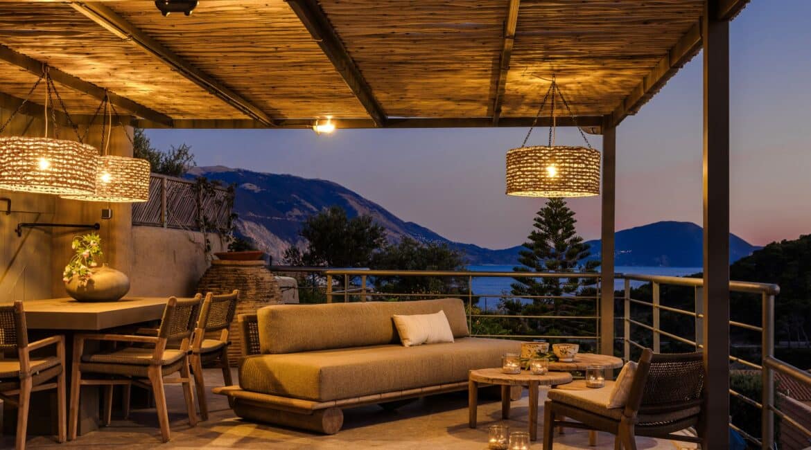 Dining terrace with Ionian Sea sunset backdrop at Villa Nikolis, Braunis Horio, Assos, Kefalonia.